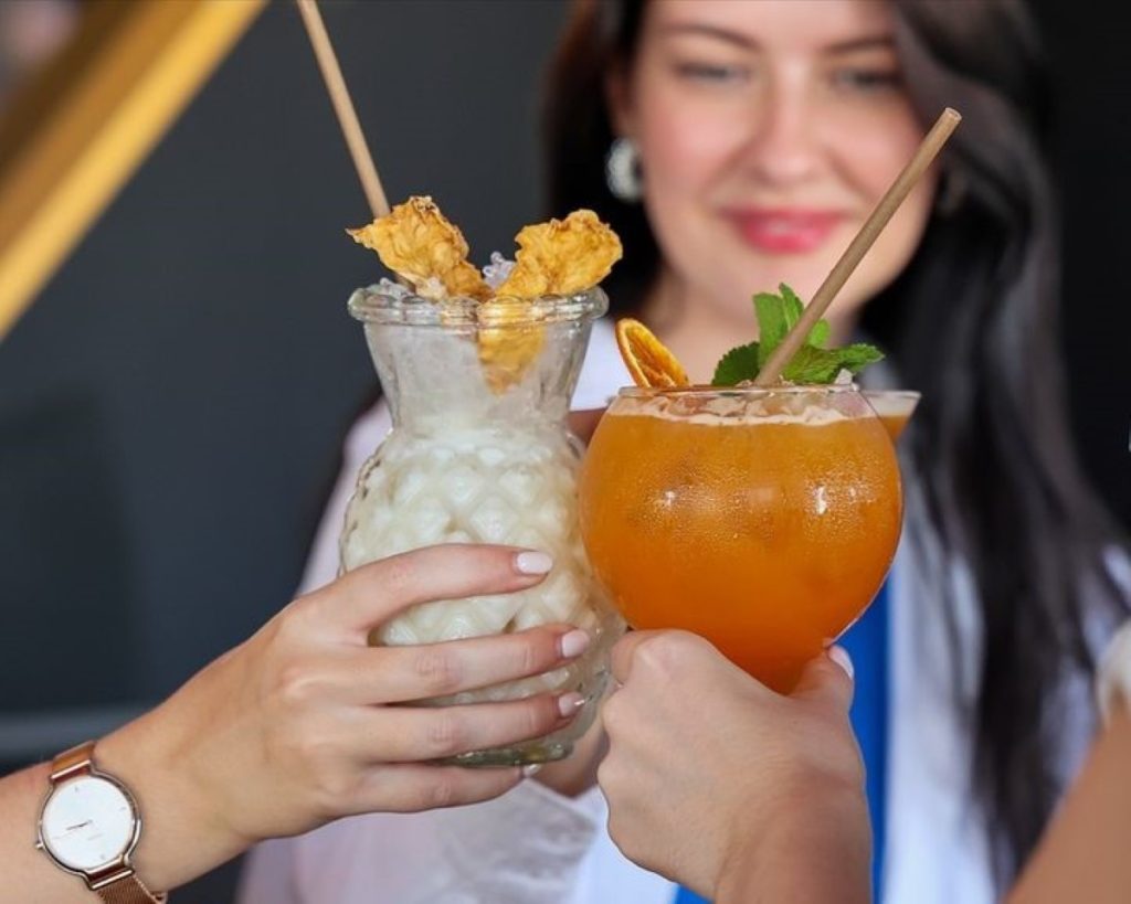 Two people toasting with cocktails