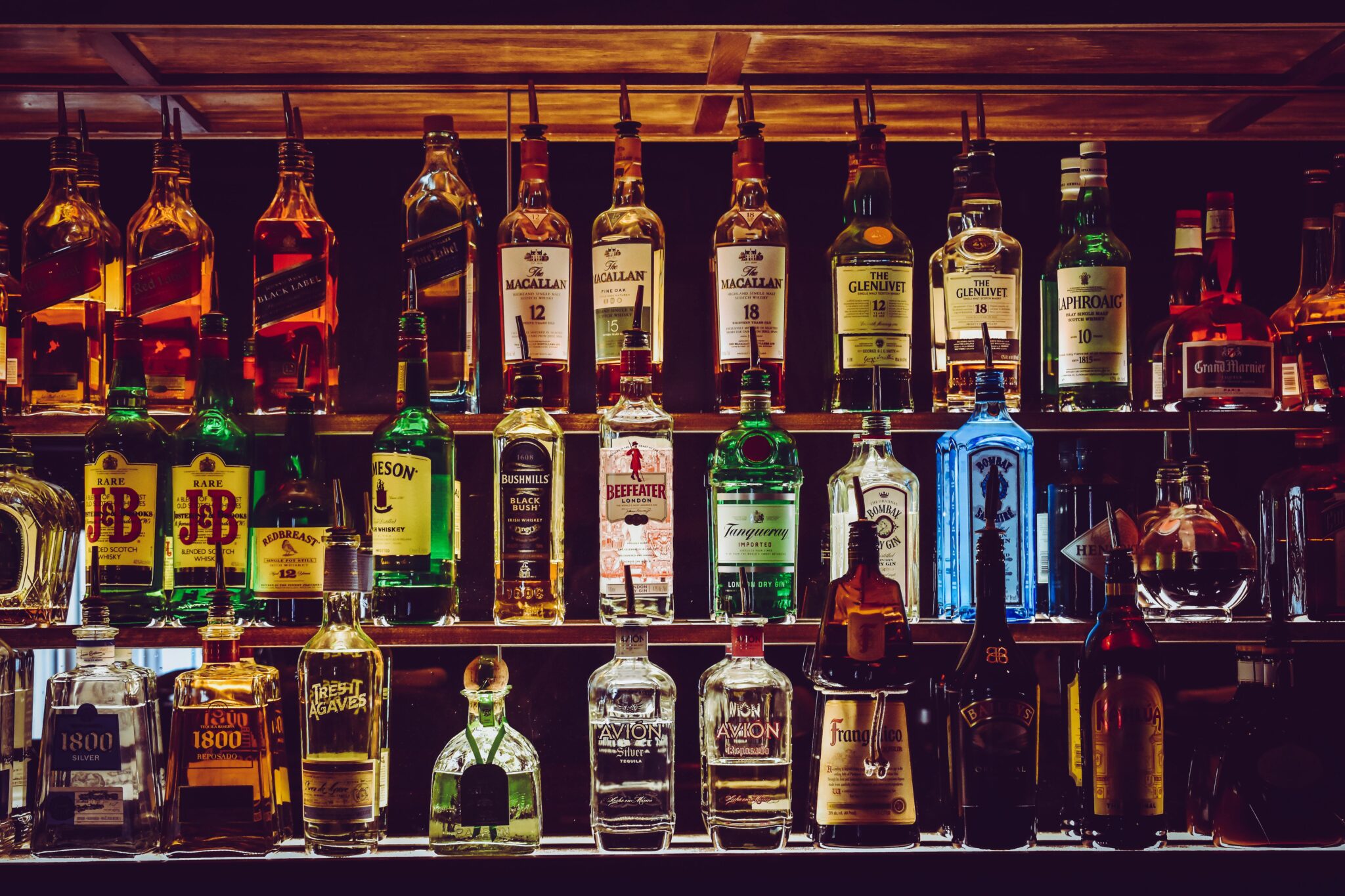 Assortment of liquor bottles on a bar shelf