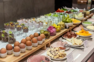 Diverse breakfast buffet with fresh fruits, cheeses, and cold cuts