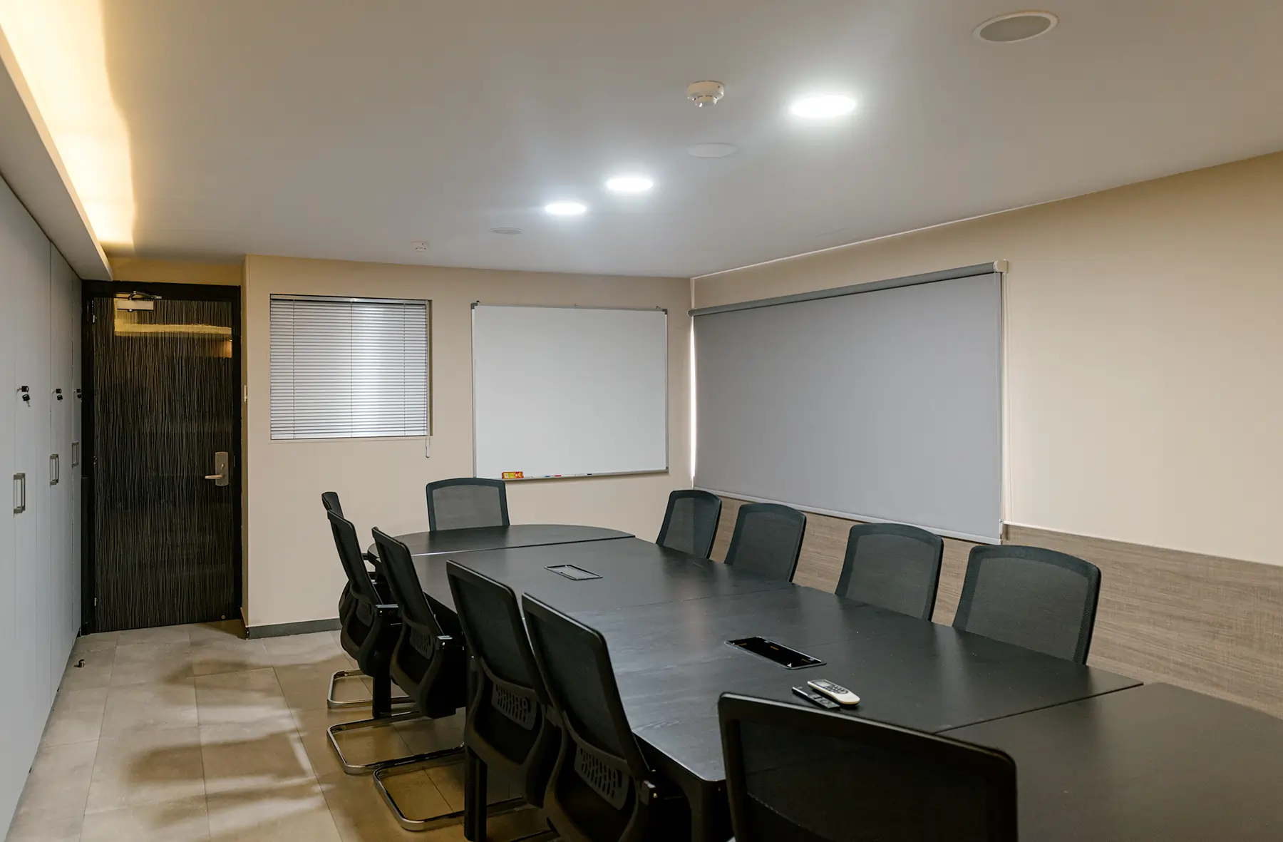 Executive meeting space with a black table and ergonomic chairs