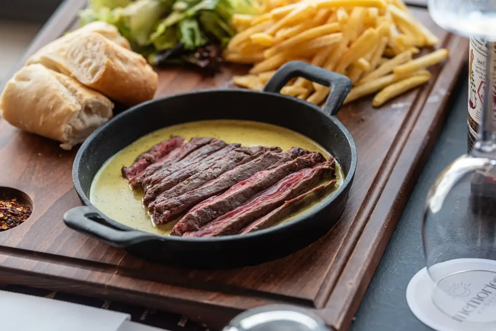 Sliced steak in signature entrecôte sauce with fries, salad and baguette at Memories L’Entrecôte’s Restaurant Rooftop Larnaca