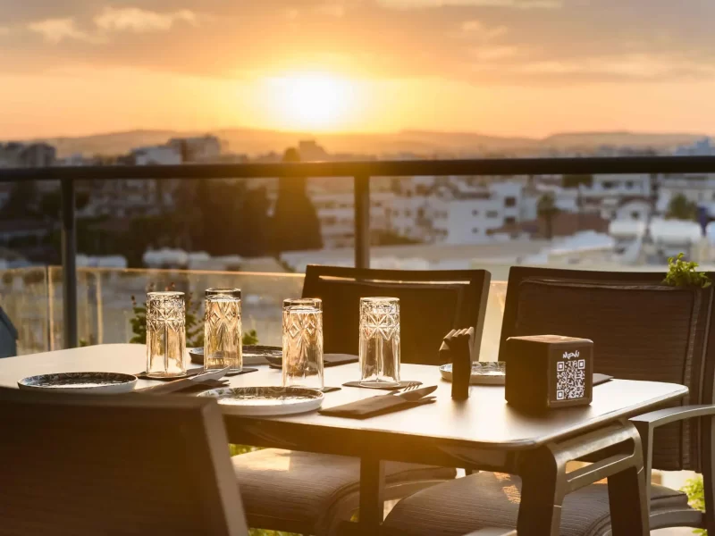 Table setup with glasses and sunset backdrop