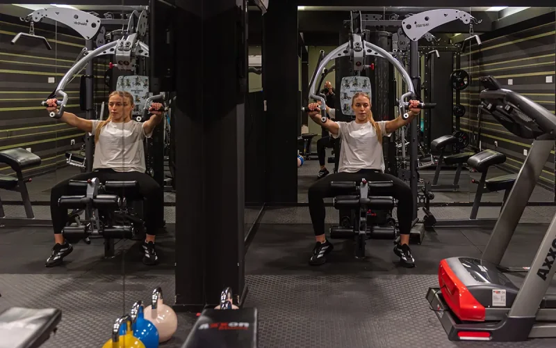Woman using chest press machine in the Rise Urban Art Hotel gym in Larnaca Cyprus