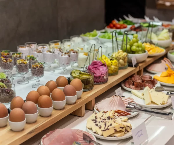 Diverse breakfast buffet with fresh fruits, cheeses, and cold cuts