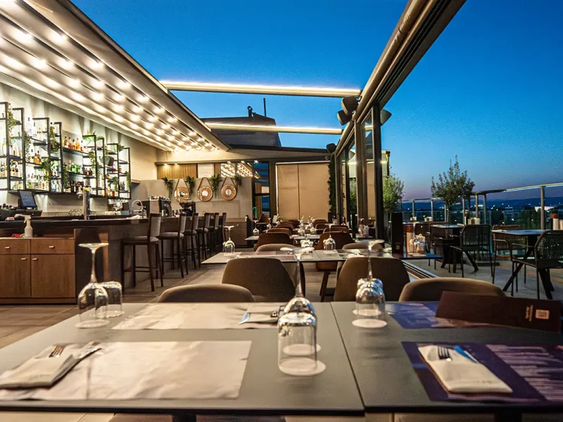 Dining tables at Memories Rooftop Restaurant overlooking Larnaca city centre and Mediterranean views